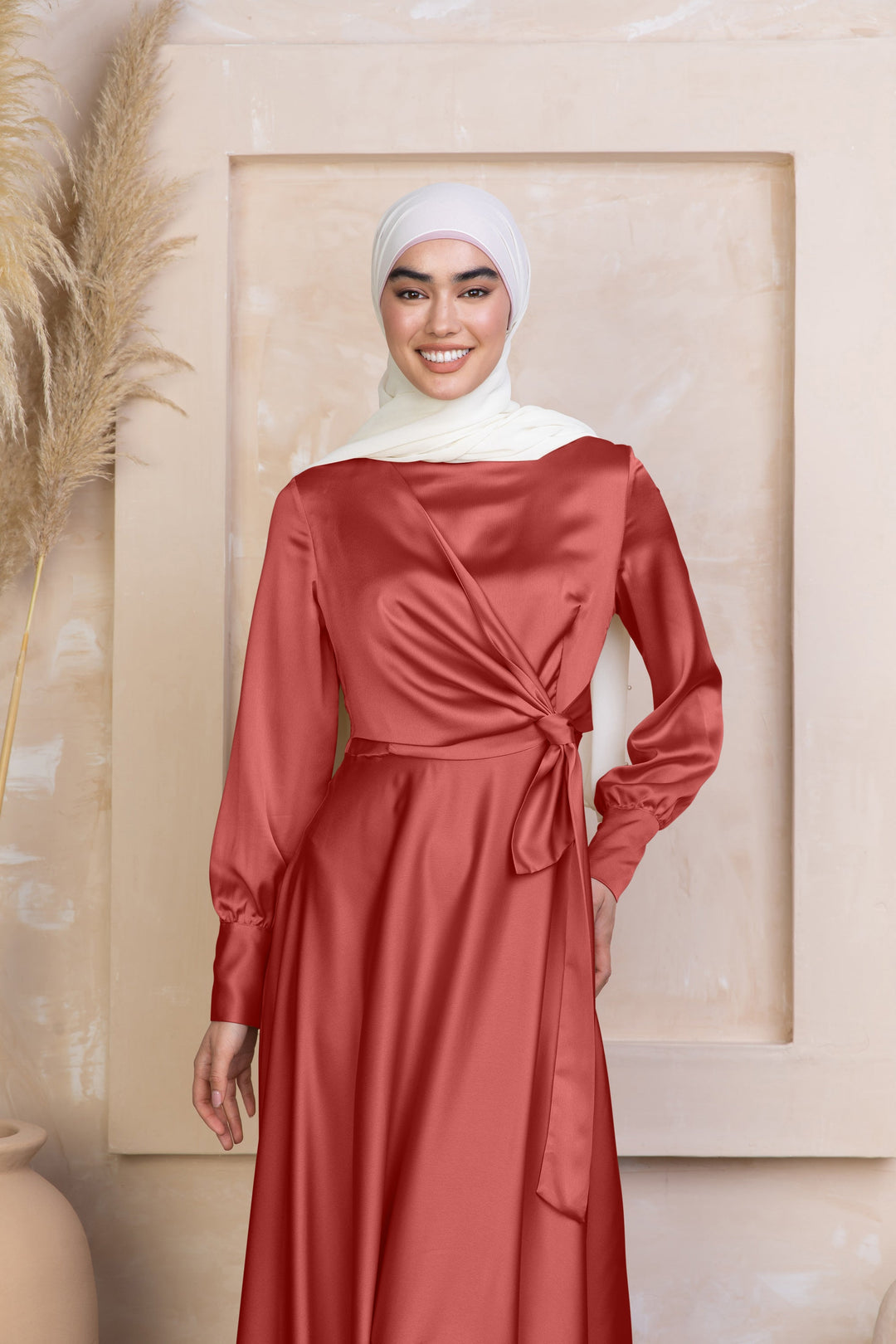 a woman wearing a red dress with a white hijab