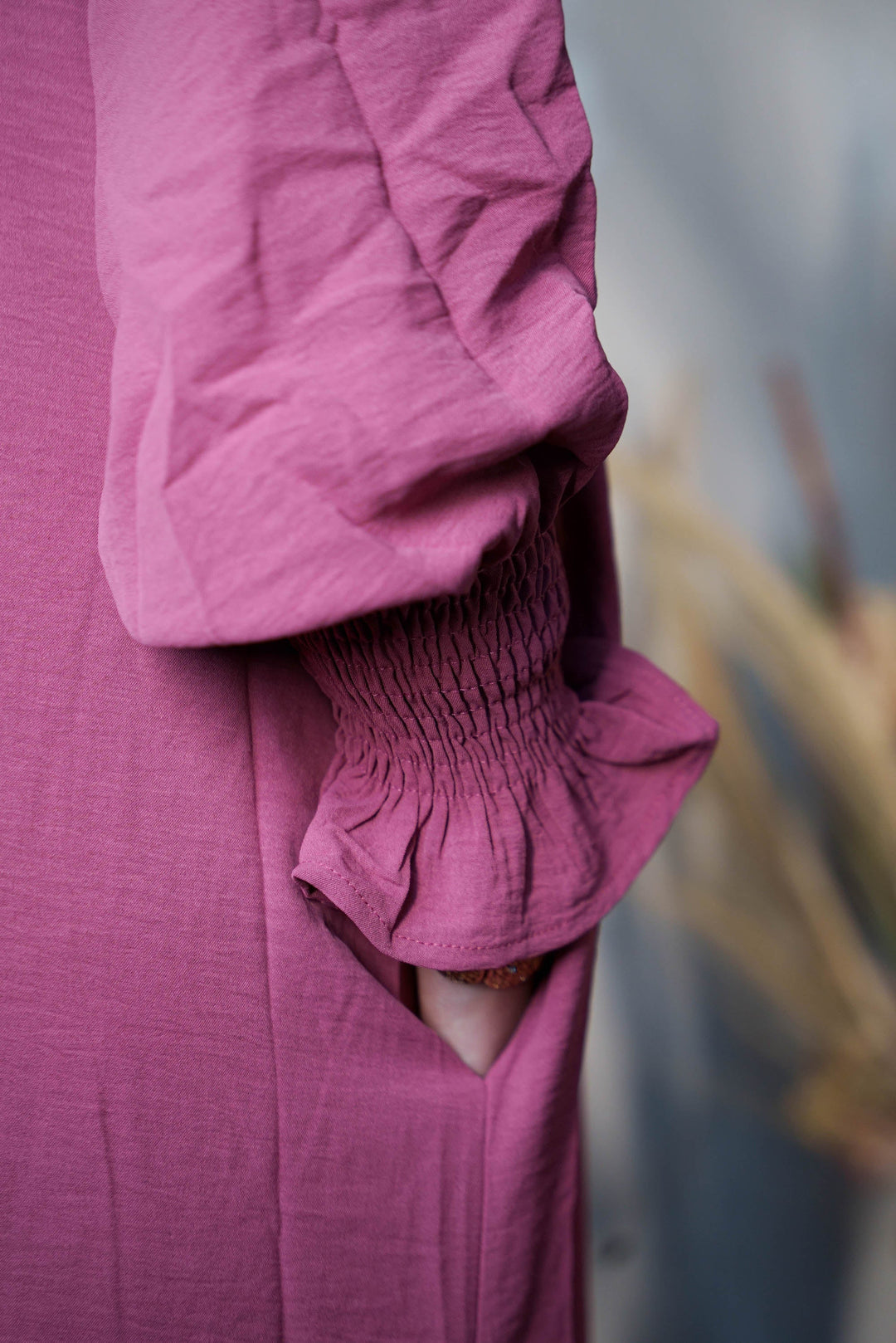 a close up of a person wearing a pink shirt