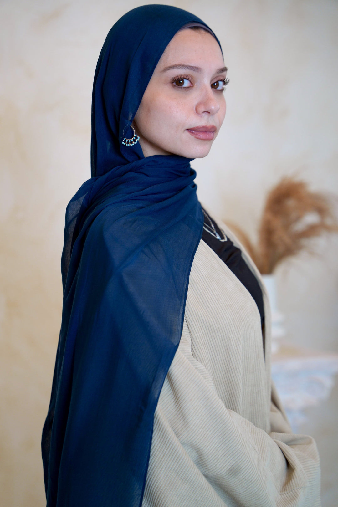 a woman with a blue shawl on her head