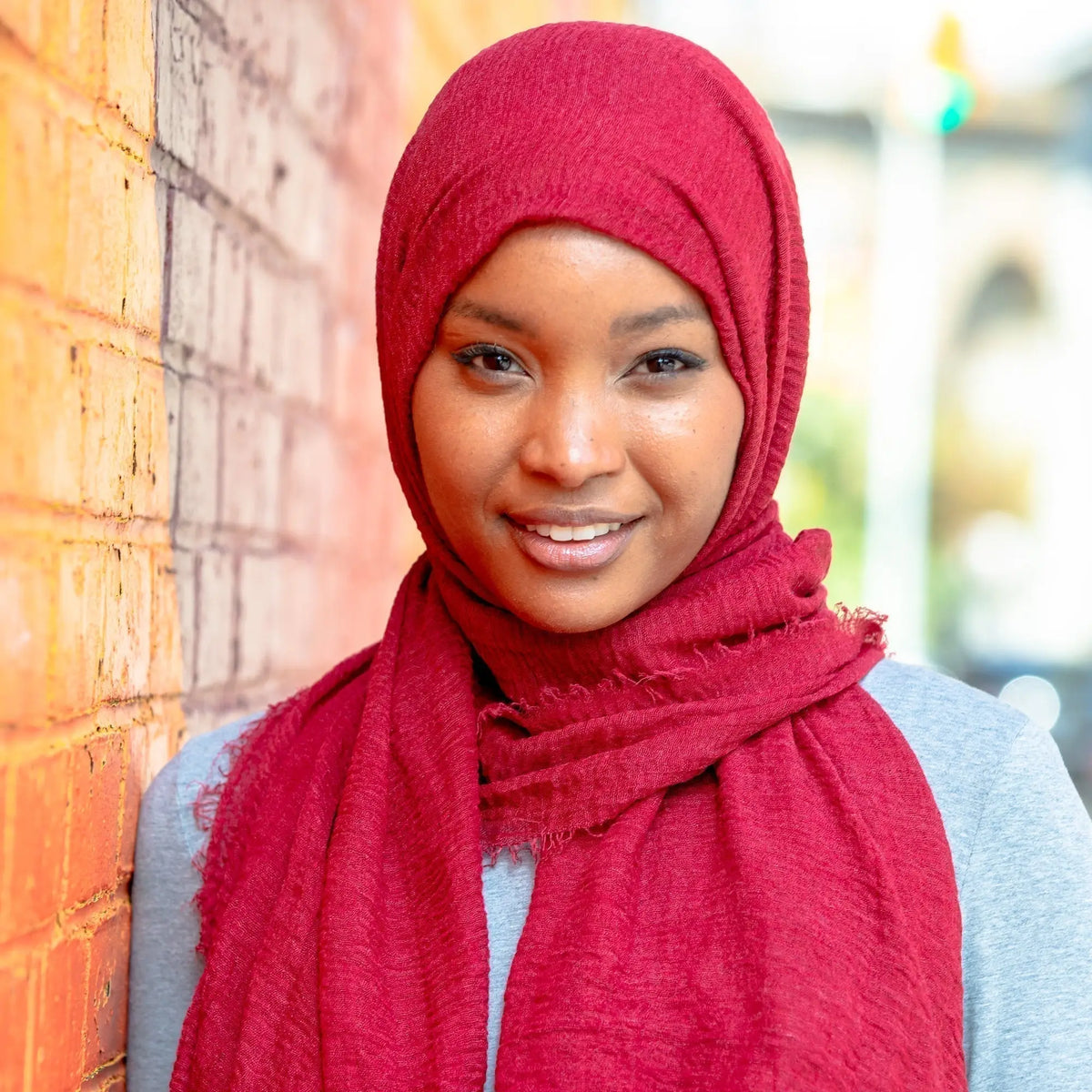 Woman wearing red Cotton Hijabs in outdoor urban setting