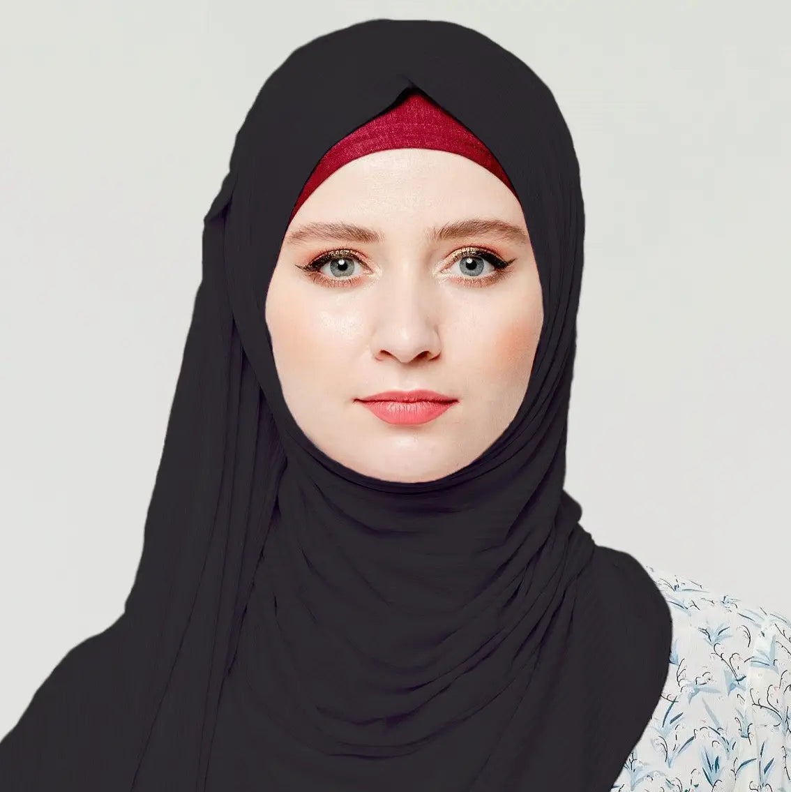 Woman wearing stretchy black Jersey Hijabs for active lifestyles, providing no-slip comfort and full coverage.