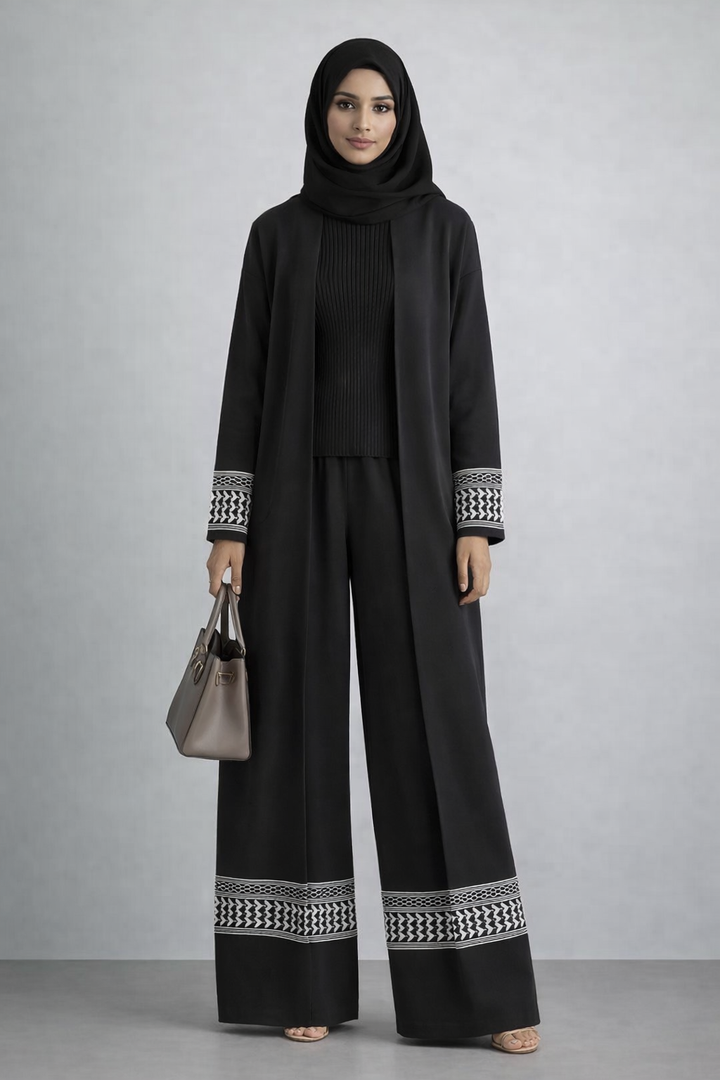 Woman wearing 3 Piece Kuffiyah Sweater Set with bell sleeves and drawstring waistband, styled with a black hijab and beige handbag.