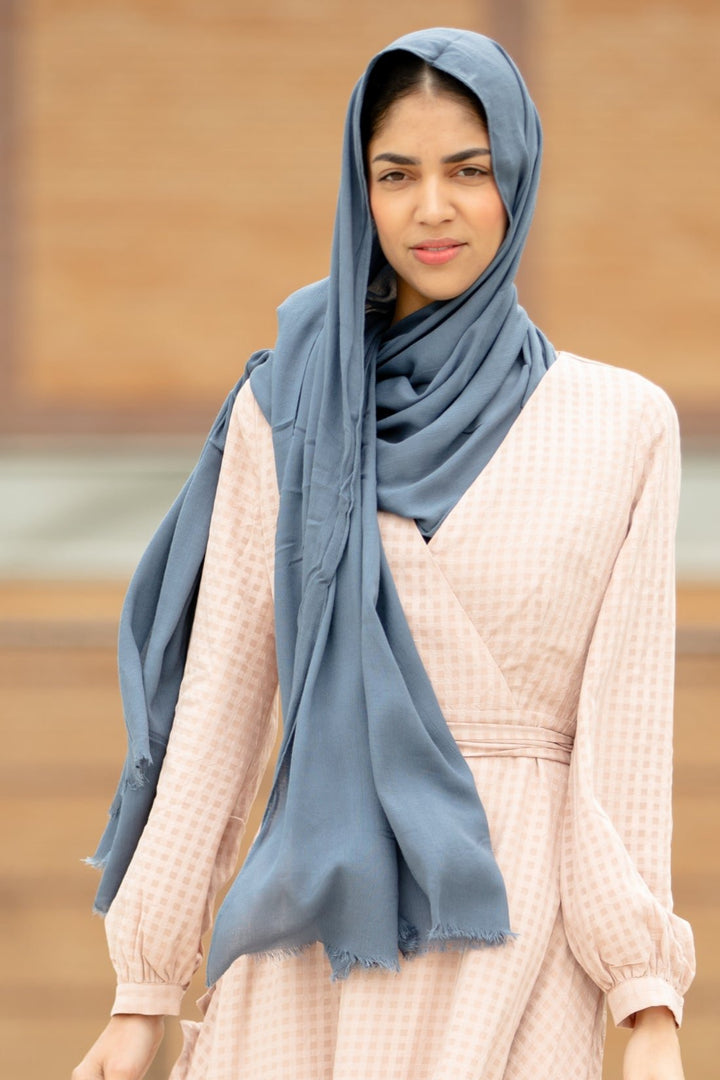 Woman wearing Grey Modal Fringe Edge Hijab from Urban Modesty, soft and elegant accessory with moisture-wicking properties.