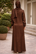 Back view of woman wearing Brown Cheetah One Piece Salah Prayer Outfit, showing the long dress and fabric pattern.