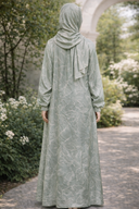 Back view of Mint Vines One Piece Salah Prayer Outfit in a garden setting, showcasing breathable fabric and elegant design for Hajj or Umrah.