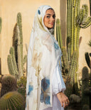 Woman wearing Abstract Modal Hijab in desert setting with cacti, ethically made in Egypt, featuring a printed design on modal cotton.
