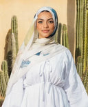 Woman wearing Abstract Modal Hijab in printed premium modal cotton, standing in front of cactus background.