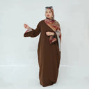 Woman wearing Brown Marbled Abaya with flowy kimono sleeves and matching hijab, showcasing elegant design and premium fabric.