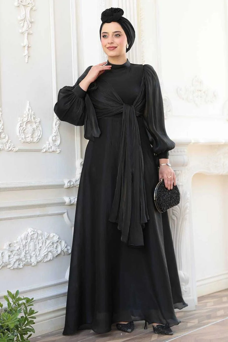 Woman wearing Black Organza Criss Cross Gown with elegant detailing, fit and flare silhouette, and crew neckline.