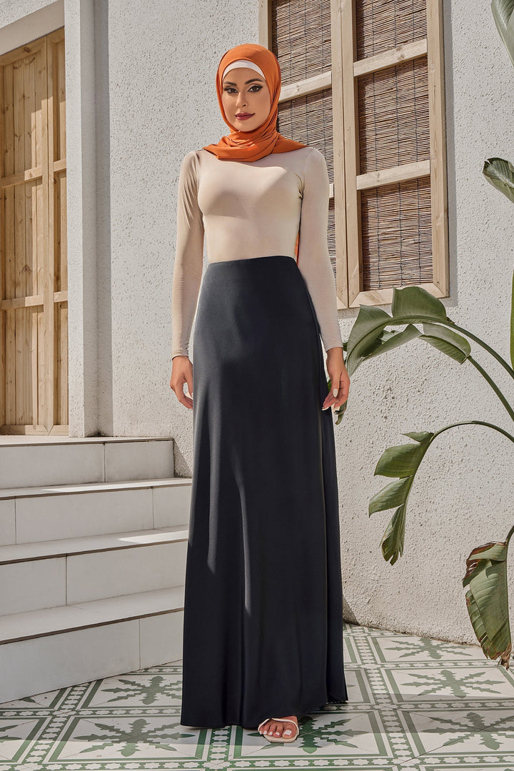 Woman in hijab wearing black satin maxi skirt