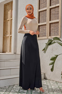 Woman in modest black satin maxi skirt