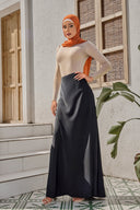 Woman in hijab wearing black satin maxi skirt and long-sleeved top