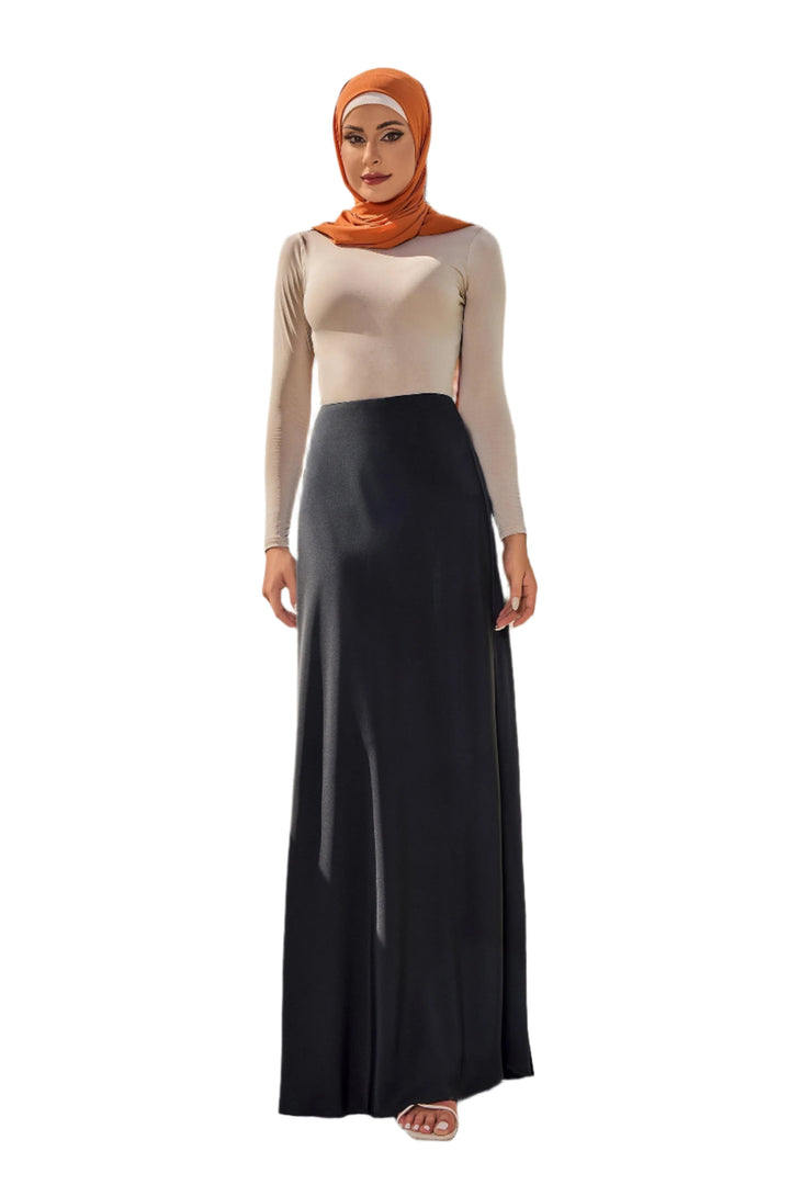 Woman in hijab wearing black satin maxi skirt and long-sleeved shirt