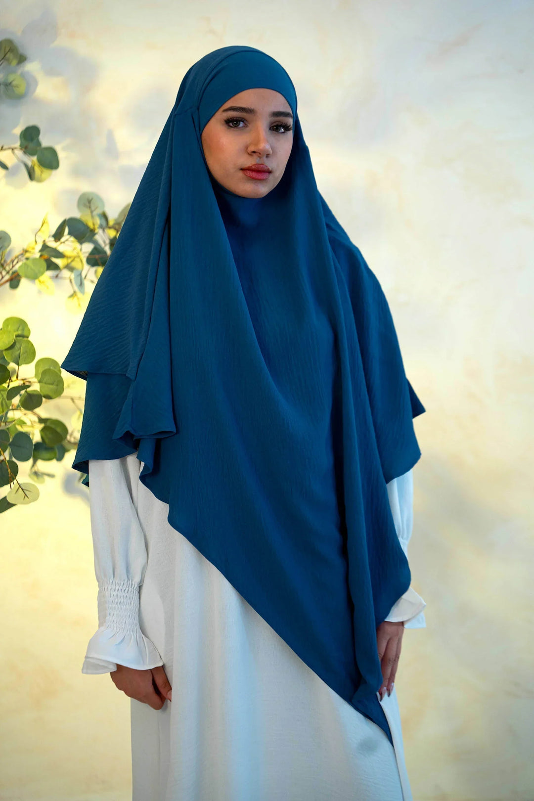 Woman wearing Blue Double Layer Khimar with white dress in natural setting