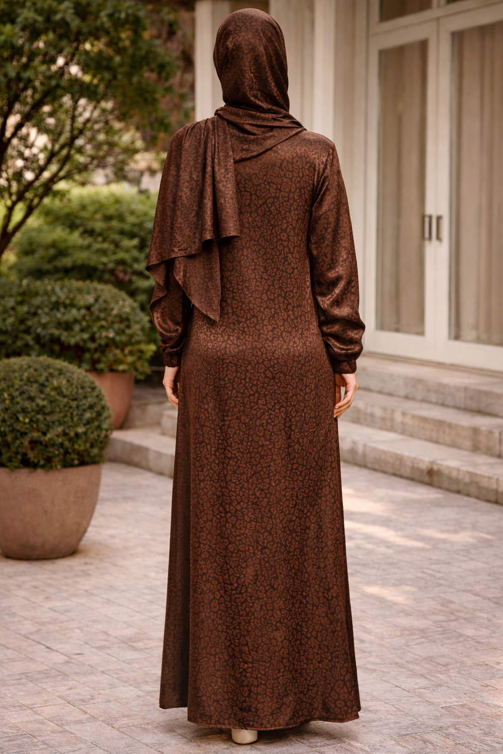 Back view of woman wearing Brown Cheetah One Piece Salah Prayer Outfit, showing the long dress and fabric pattern.