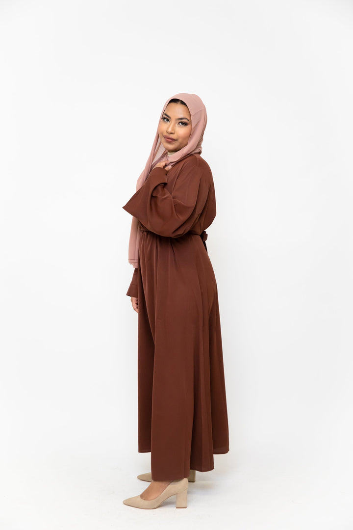 Woman in brown abaya and pink hijab maxi dress