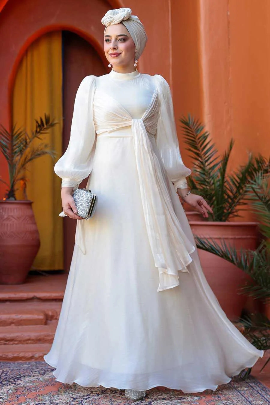 Model wearing luxurious Cream Organza Criss Cross Gown with fit and flare design, perfect for elegant events, by Urban Modesty.