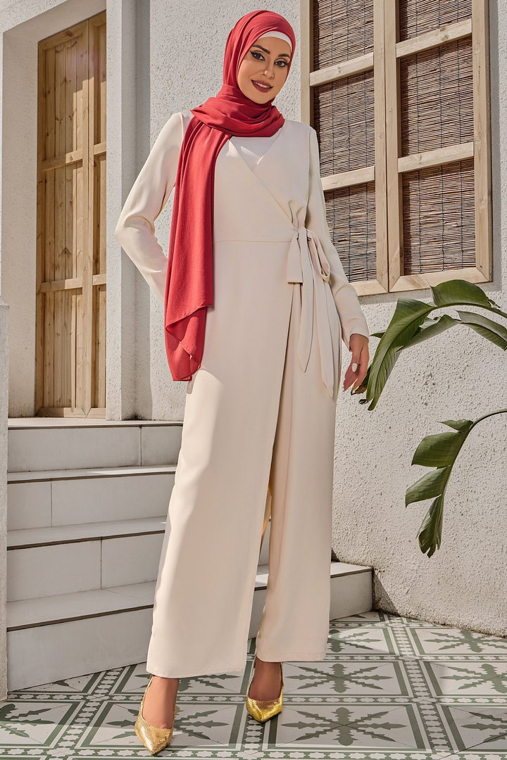 Woman in red hijab wearing cream side knot jumpsuit