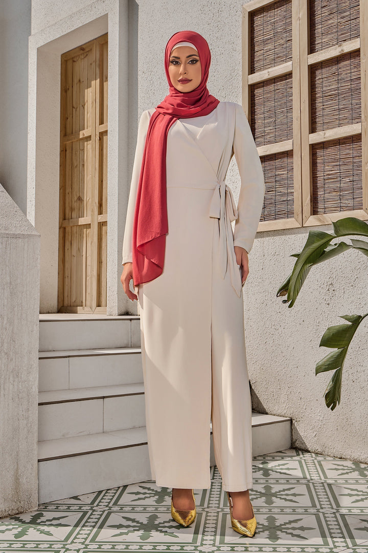 Woman in cream side knot jumpsuit, modest dress and hijab