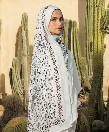 Woman wearing Damask Modal Hijab in front of cacti, showcasing premium modal cotton and intricate damask print, ethically made in Egypt.