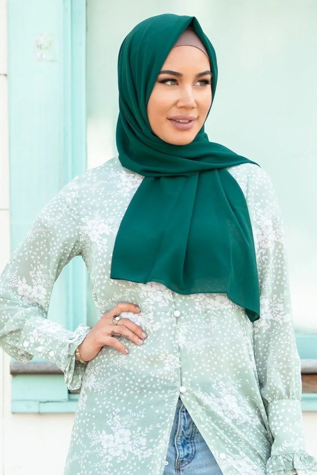 Woman wearing Forest Green Chiffon Hijab with floral blouse, perfect for stylish everyday wear.
