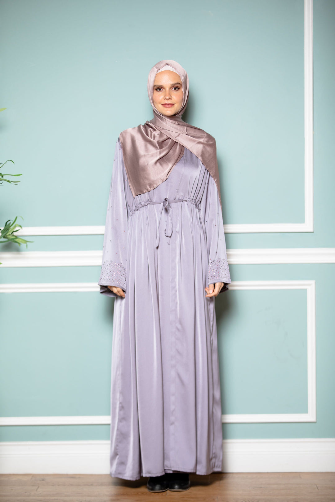 Woman in lilac satin hijab and gray drawstring open front abaya