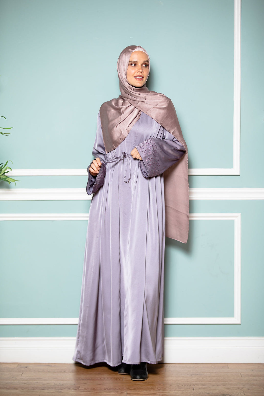 Woman in lavender hijab and gray satin open-front abaya