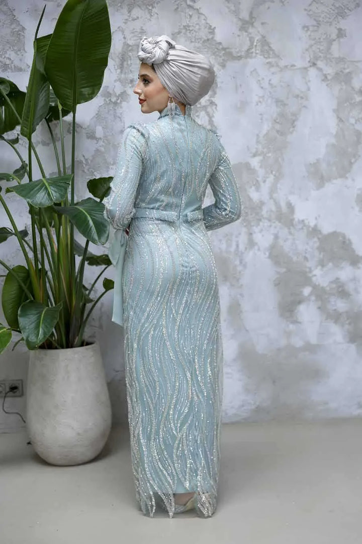 Back view of a model wearing the Mint Beaded Gown from Urban Modesty, showcasing the elegant beaded design and crew neckline.