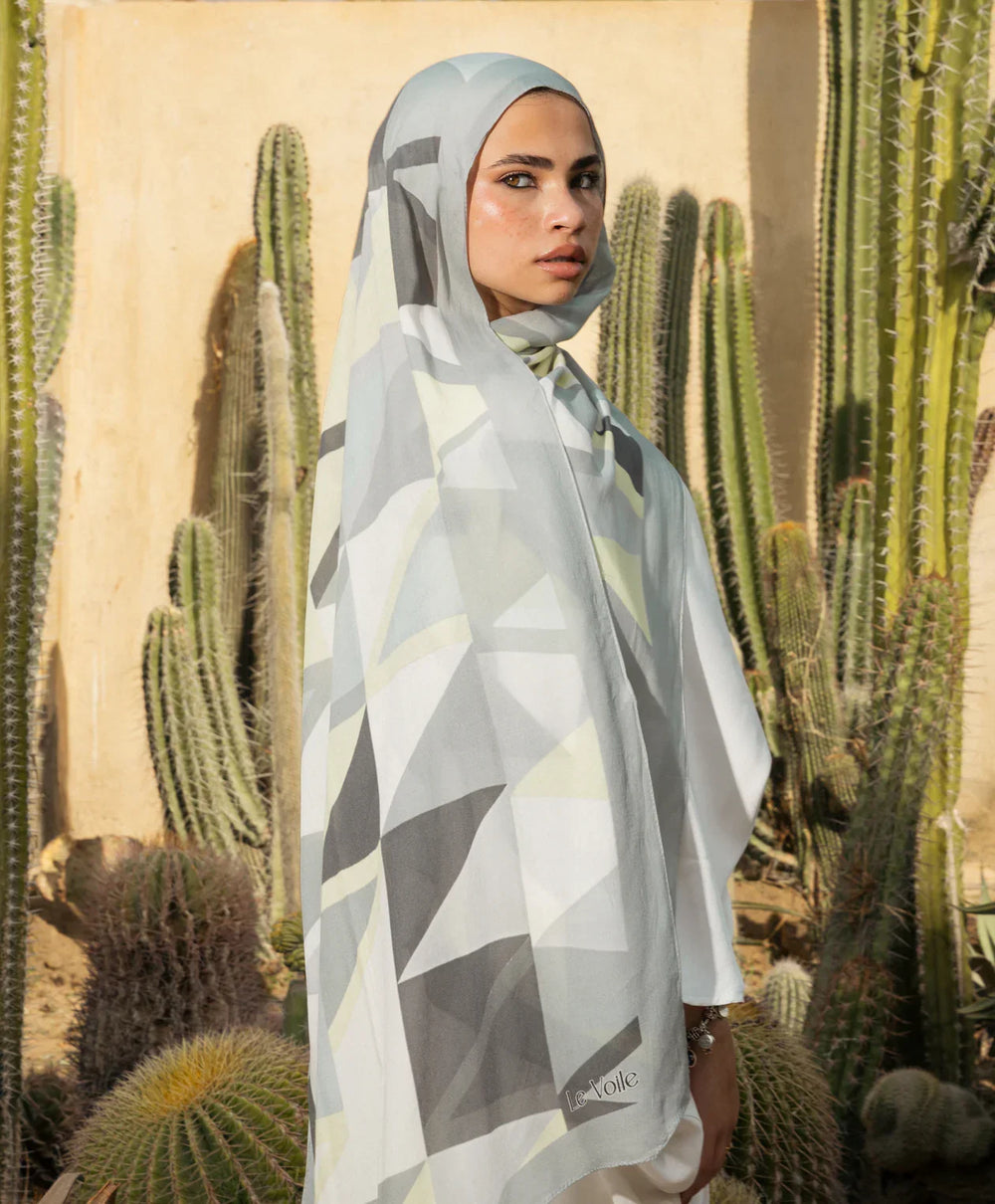 Woman wearing Mosaic Modal Hijab in desert setting with cactus background, made of premium modal cotton, ethically crafted in Egypt