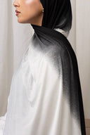 Side profile of woman wearing Ombré Jersey Hijab in black and white, showcasing its lightweight draping and elegant design.