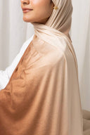 Woman wearing lightweight Ombré Jersey Hijab in brown and beige hues, perfect for easy and effortless draping.