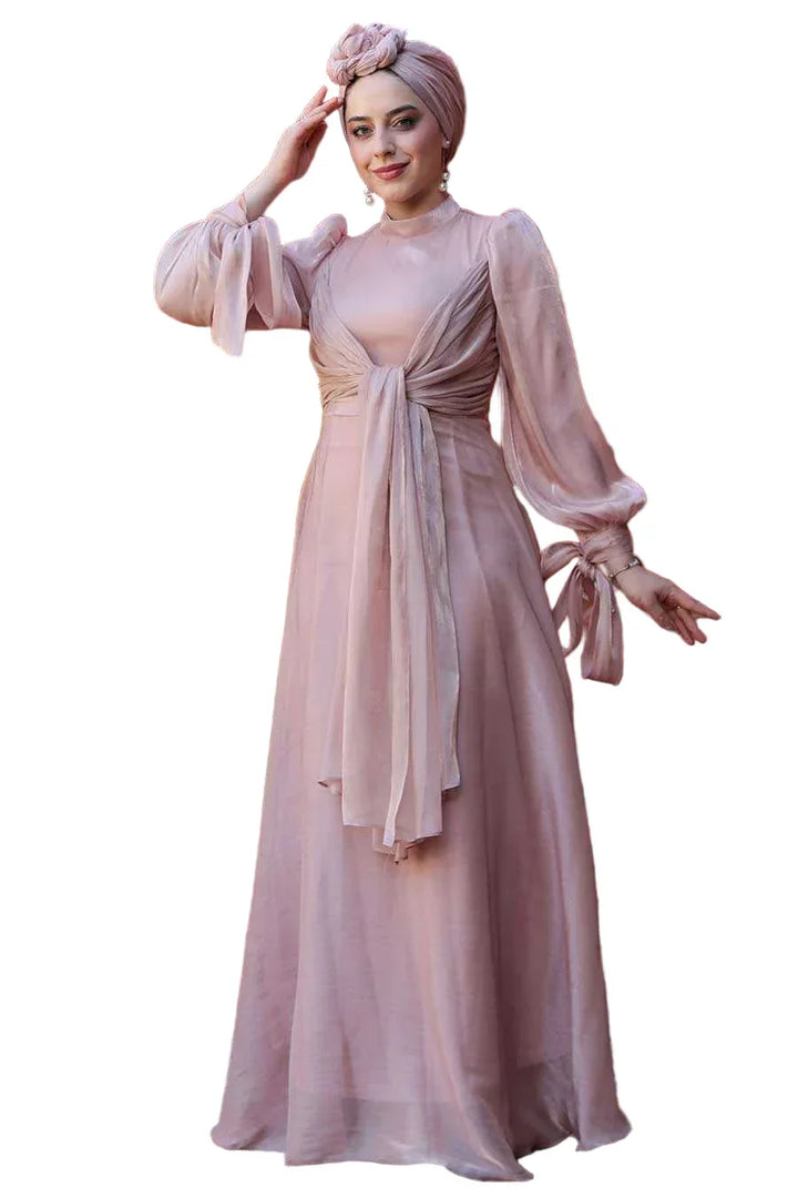 Model wearing Pink Organza Criss Cross Gown with elegant details and long sleeves, showcasing sophisticated style and premium design.