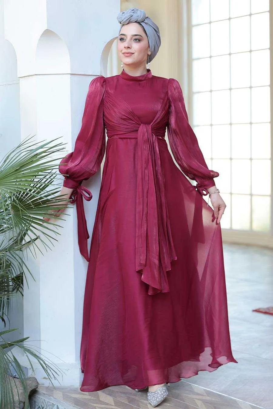 Model in Red Organza Criss Cross Gown with a fit and flare silhouette and elegant long sleeves, highlighting luxury fashion from Urban Modesty.
