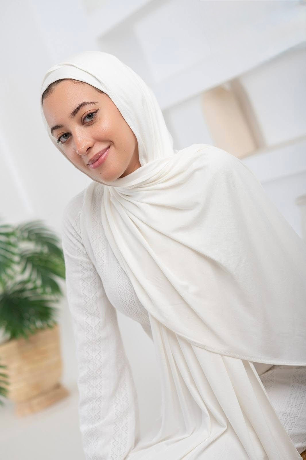 Woman wearing White Jersey Hijab with Undercap, lightweight and easy to drape, elegant design for effortless style.
