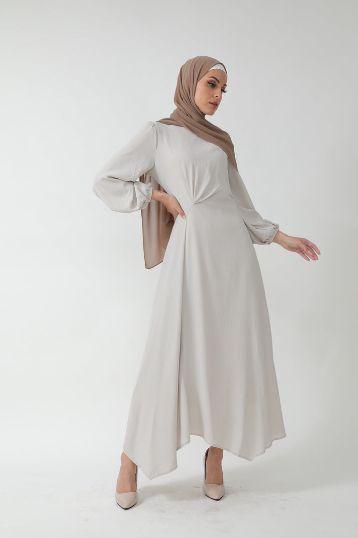 Woman in a modest, light-colored metallic pinstripe long sleeve maxi dress