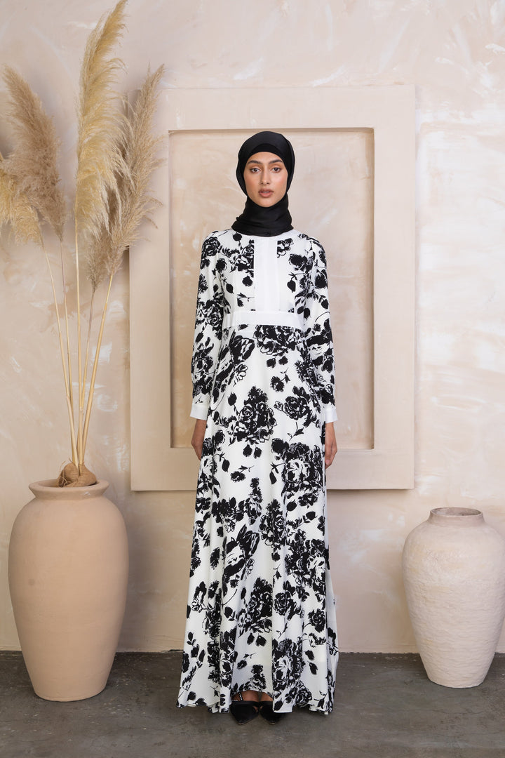 Woman wearing a Black and White Floral Maxi Dress with sleeves and a black head covering