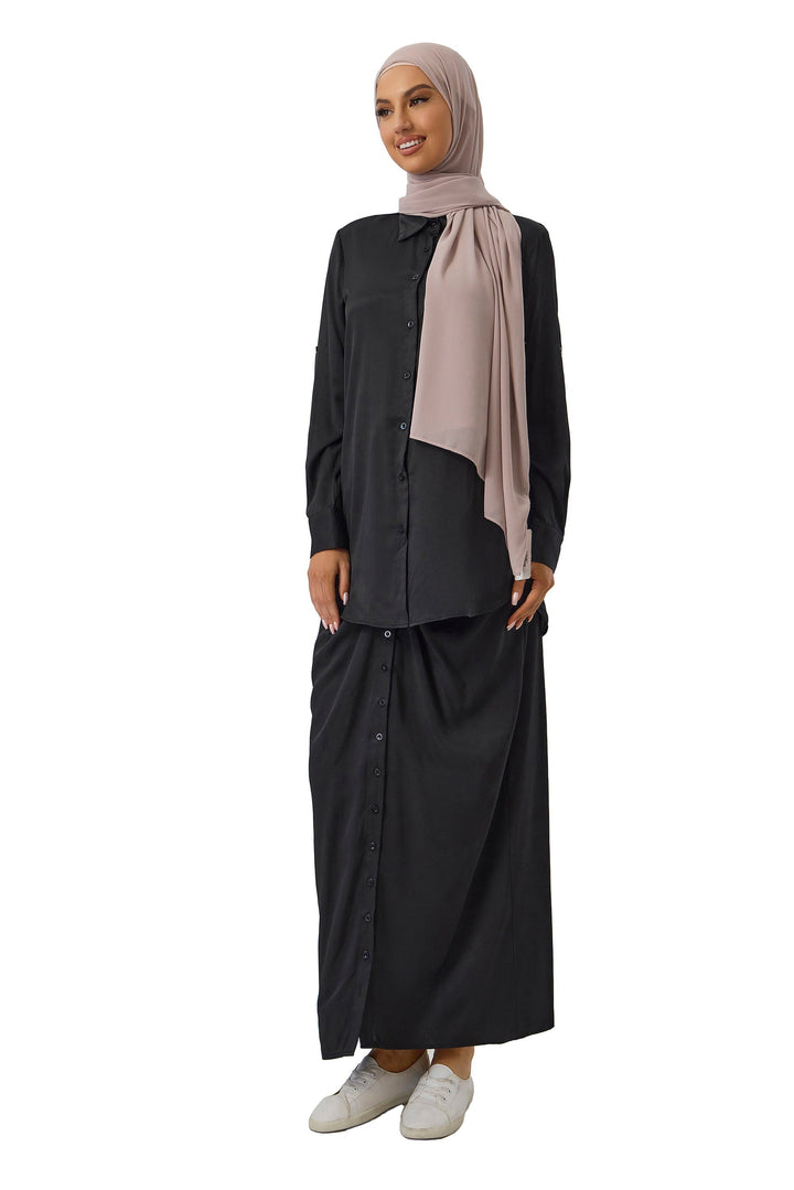 Woman in black button-down outfit with hijab wearing a black skirt set on clearance