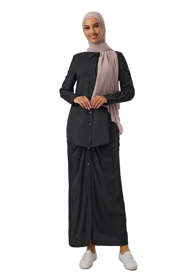 Woman in black button dress with hijab, showcasing a stylish skirt set