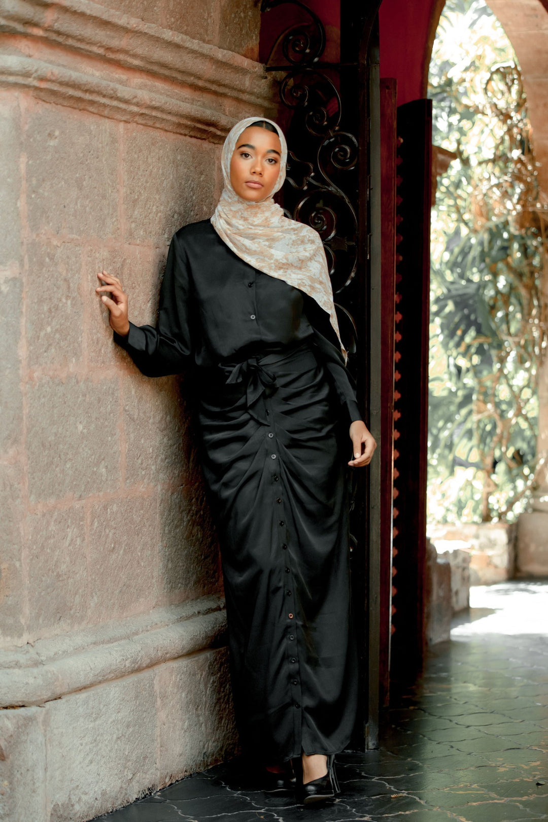 Woman in black satin dress and hijab showcasing Black Button Down Shirt and Skirt Set