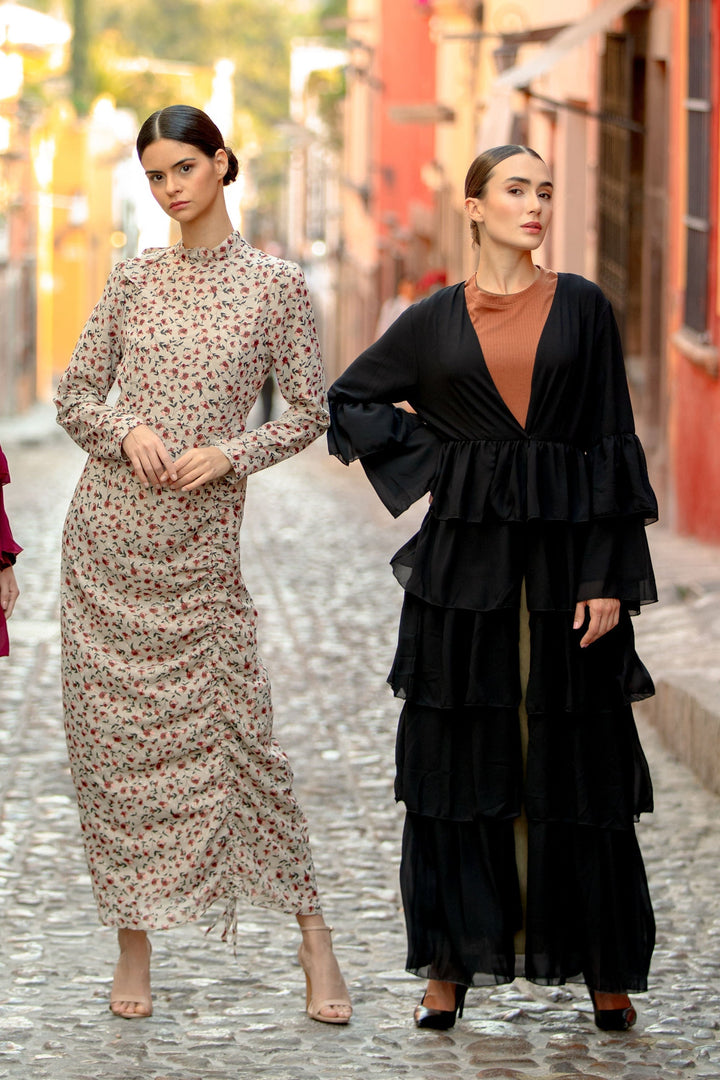 Two women modeling the Black Cascading Ruffles Open Front Abaya with tiered ruffles