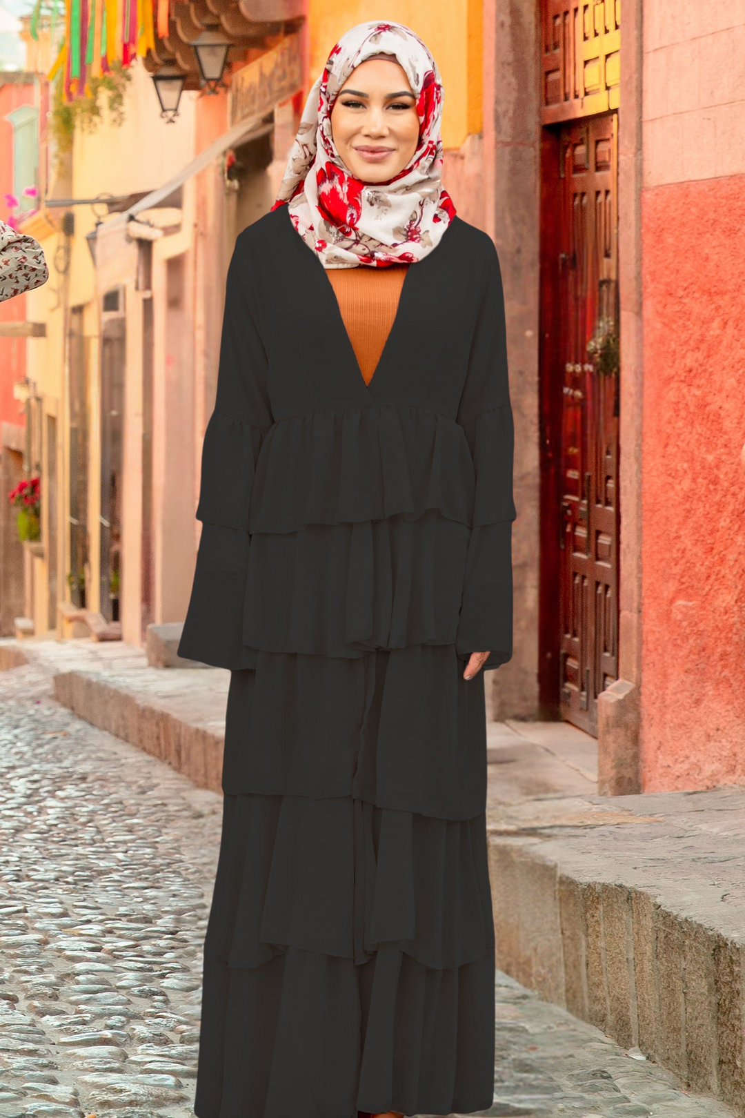 Tiered black modest dress featuring black cascading ruffles for an elegant look