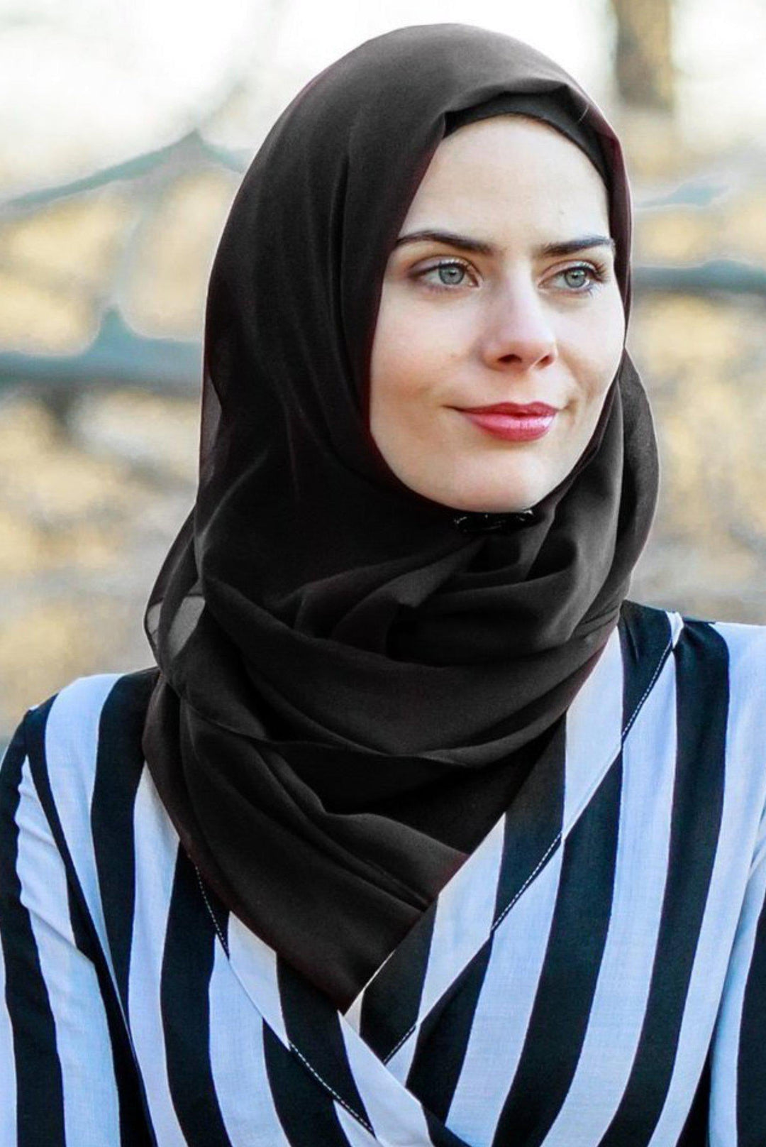 Woman wearing a black chiffon hijab, showcasing elegant scarf style