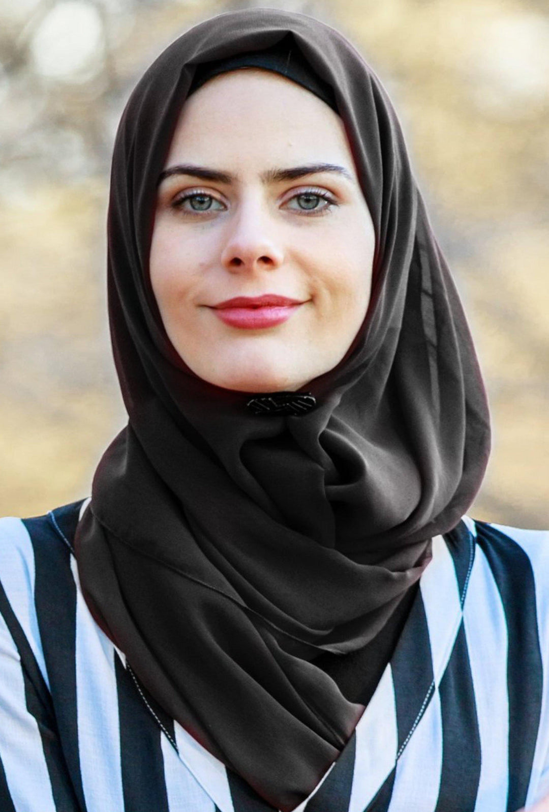 Woman wearing a black chiffon hijab scarf, perfect for stylish and modest fashion