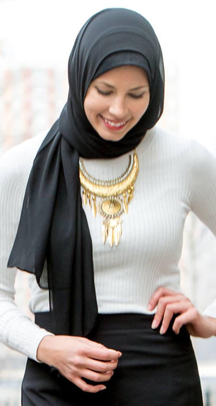 Woman in hijab wearing a statement necklace and a Black Chiffon Hijab scarf