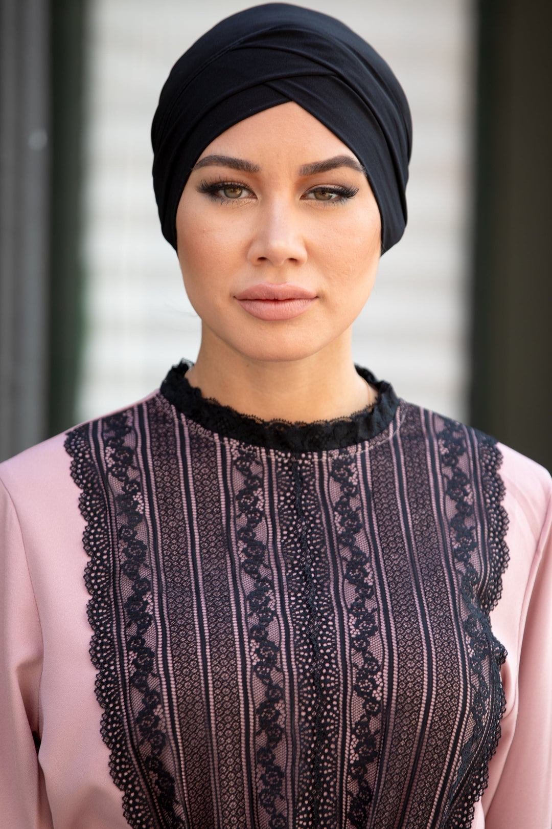 Woman wearing Black Criss-Cross Cap Hijab UnderScarf with pink lace-trimmed dress