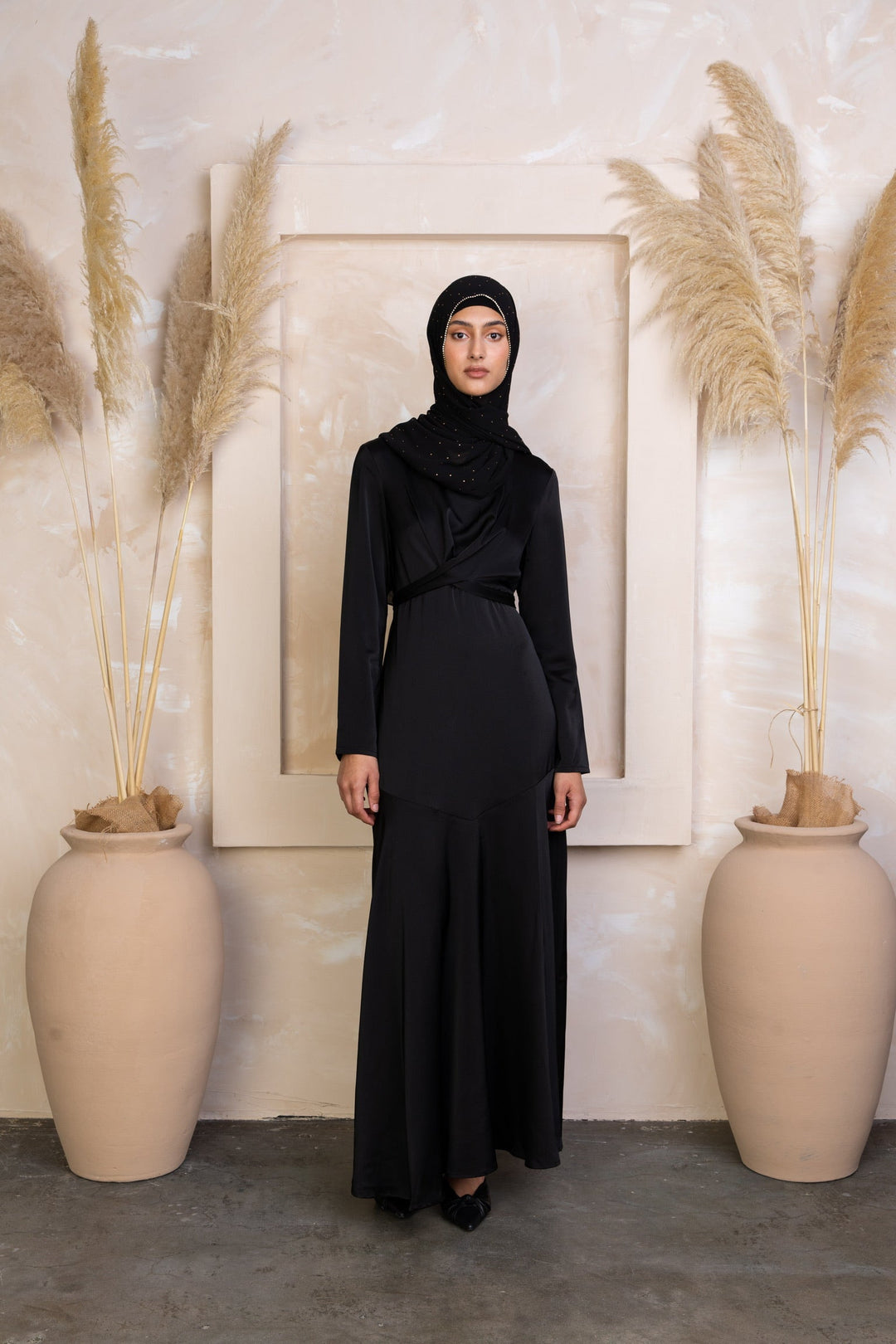 Woman in black modest dress and hijab wearing Black Criss Cross Satin Maxi Dress