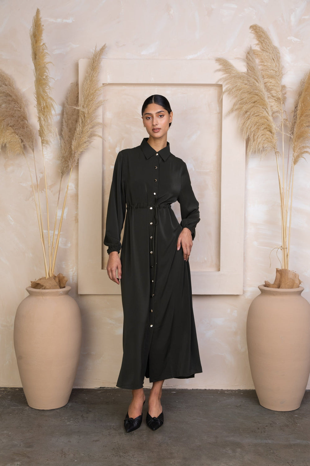 Woman wearing a long-sleeved button-down dress with a Black Drawstring Non-Sheer Maxi Cardigan