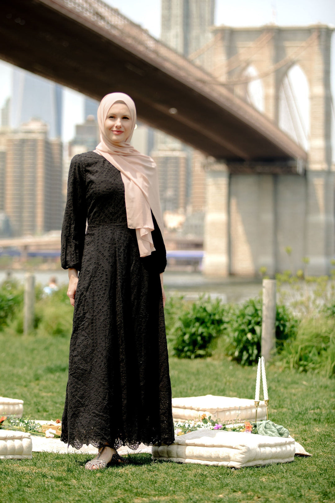 Woman in black lace dress with hijab showcasing Black Eyelet Long Sleeve Maxi Dress