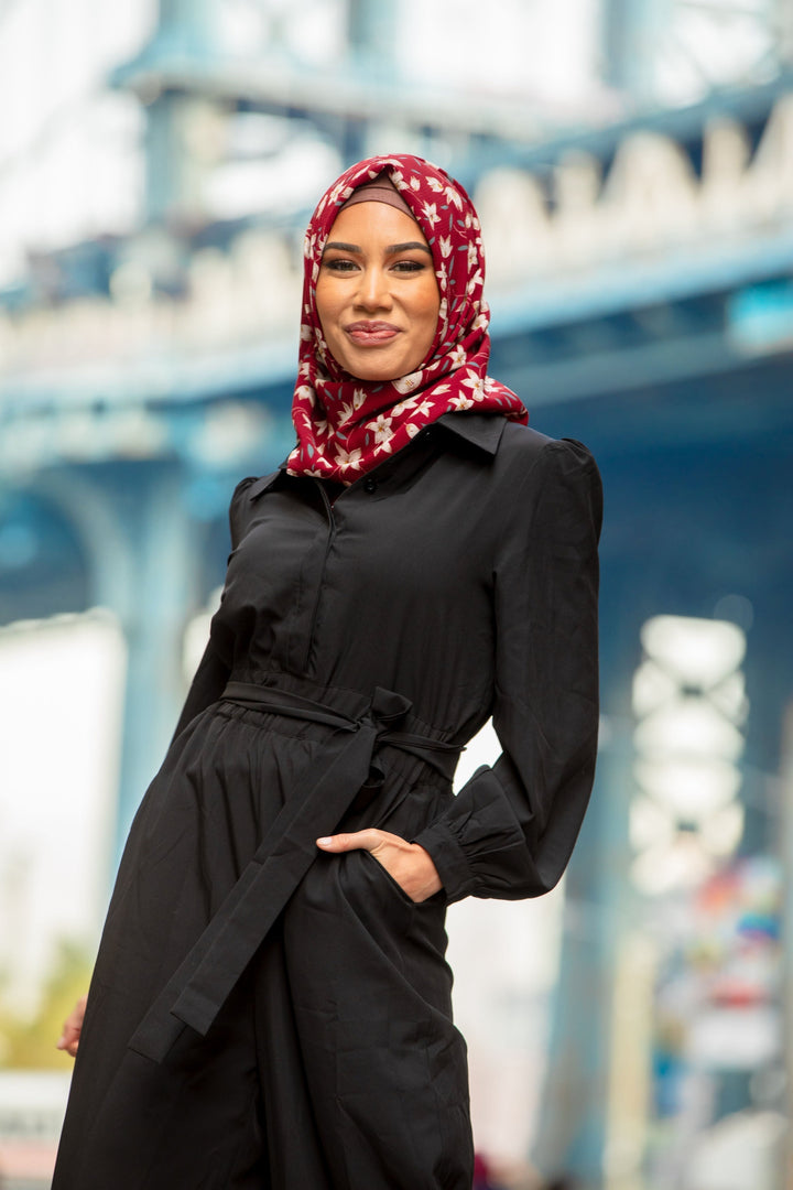 Woman in black jumpsuit with patterned hijab showcasing the Black Lattice Jumpsuit