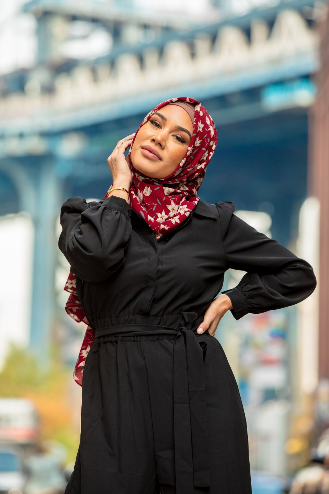 Woman in black jumpsuit and floral hijab showcasing Black Lattice Jumpsuit on clearance